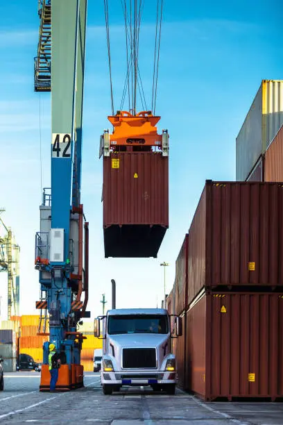 A freight train loaded with shipping containers, representing the role of rail transportation in freight economics and the movement of goods across long distances.