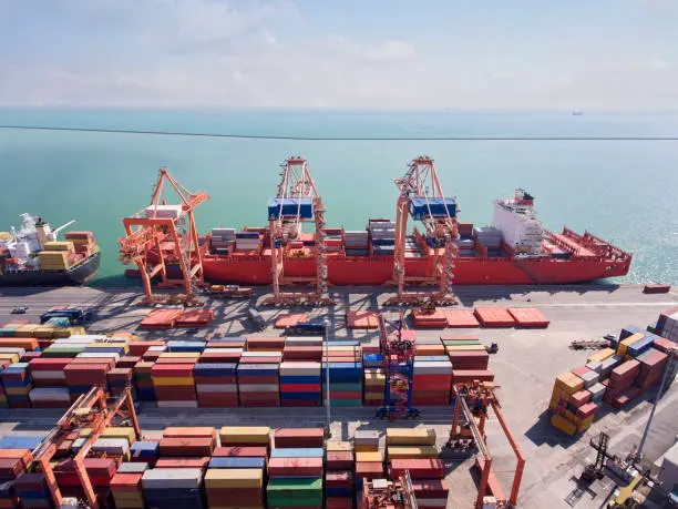 A rail yard with freight trains and cargo containers, illustrating the operational intricacies of rail freight logistics and the integration of rail transportation with intermodal terminals for seamless cargo movement.