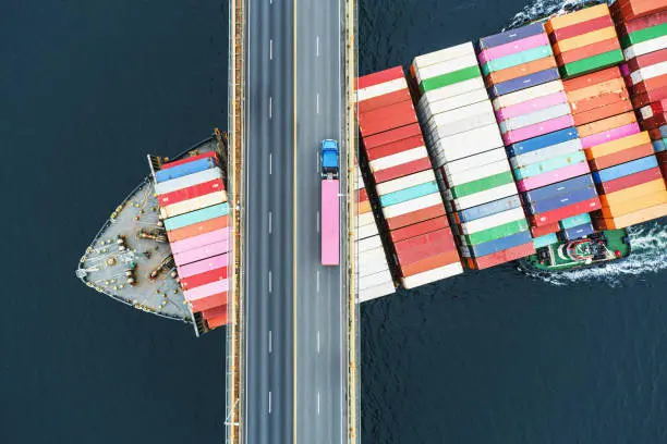 A cargo ship docked at a port, representing the importance of efficient freight networks in global trade and logistics operations.